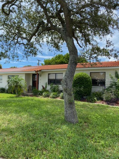 64 Cardinal Drive, Unit B Ormond Beach, FL 32176 - Photo 1 of 1 a front view of a house with garden