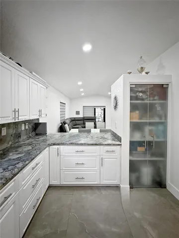 a kitchen with stainless steel appliances granite countertop a sink and cabinets
