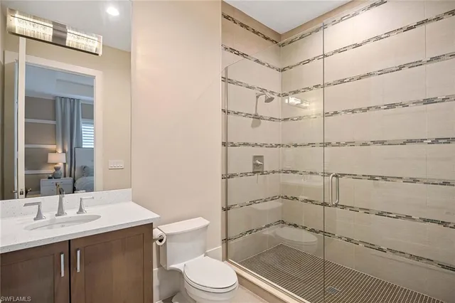 a bathroom with a shower toilet and sink