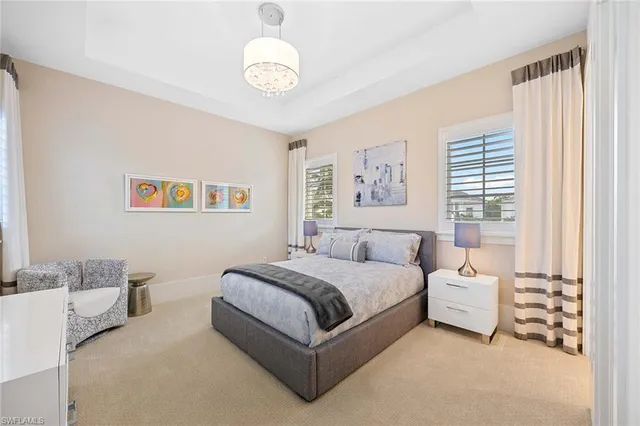 a spacious bedroom with a bed and a large window