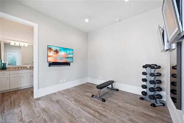 a view of a house with a yard and a large tree