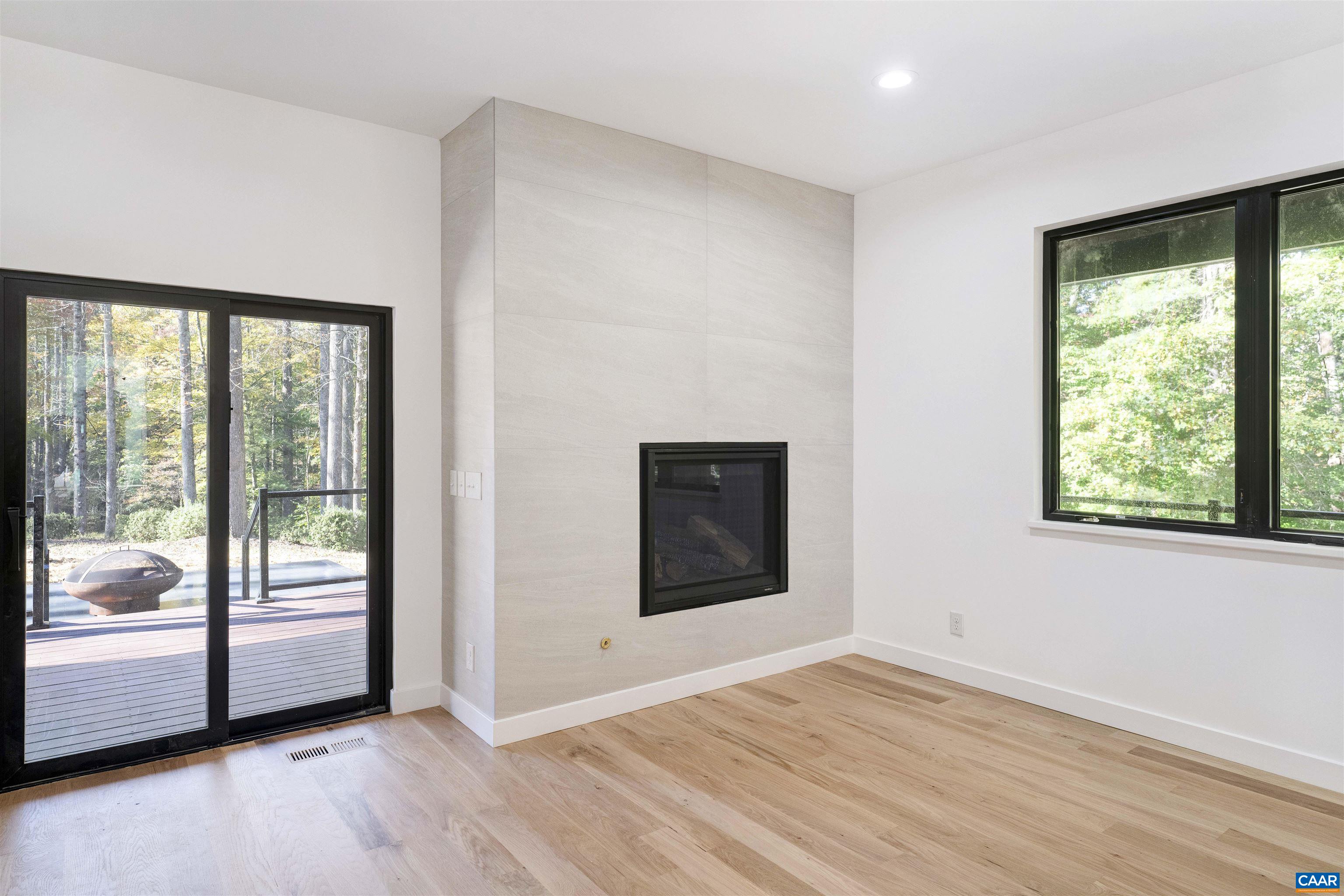 2482 Schelford Farm Road Charlottesville, VA 22901 - Photo 13 of 39 a view of an empty room with glass door and a window