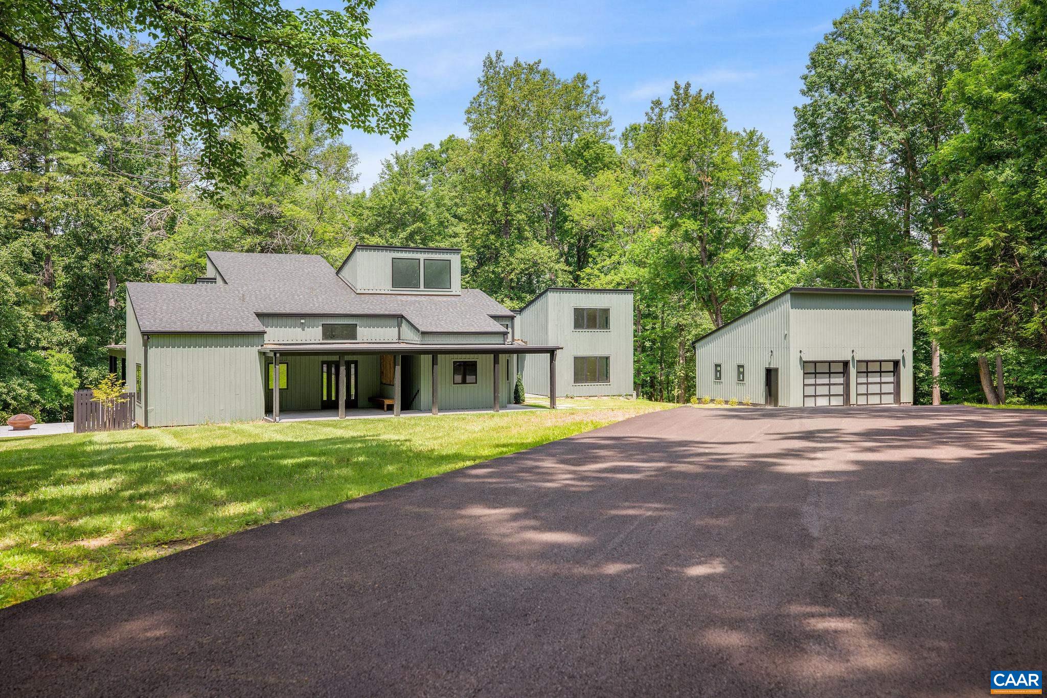 2482 Schelford Farm Road Charlottesville, VA 22901 - Photo 17 of 39 a front view of a house with a garden and trees