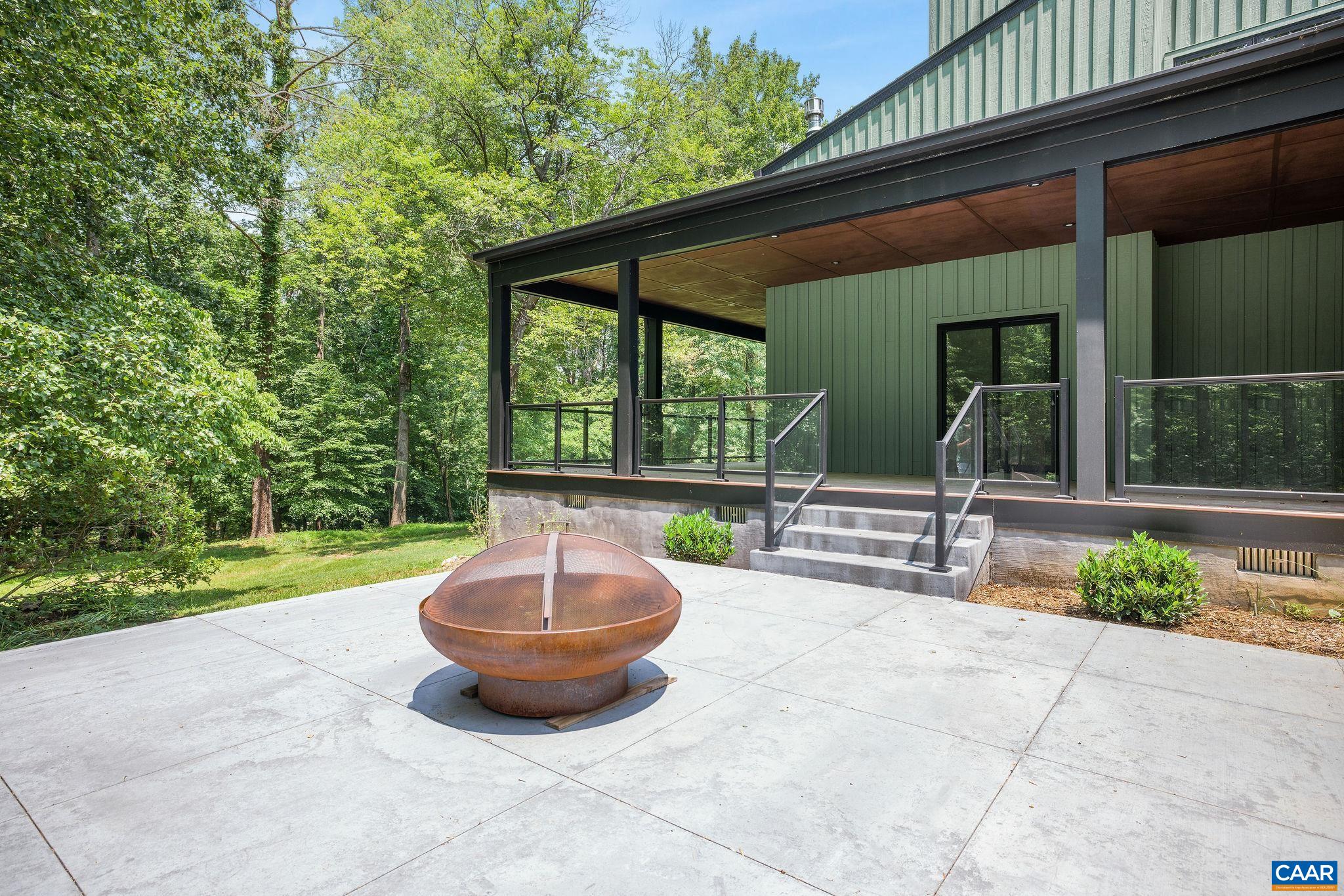 2482 Schelford Farm Road Charlottesville, VA 22901 - Photo 23 of 39 a view of a patio with a table and chairs and a small yard