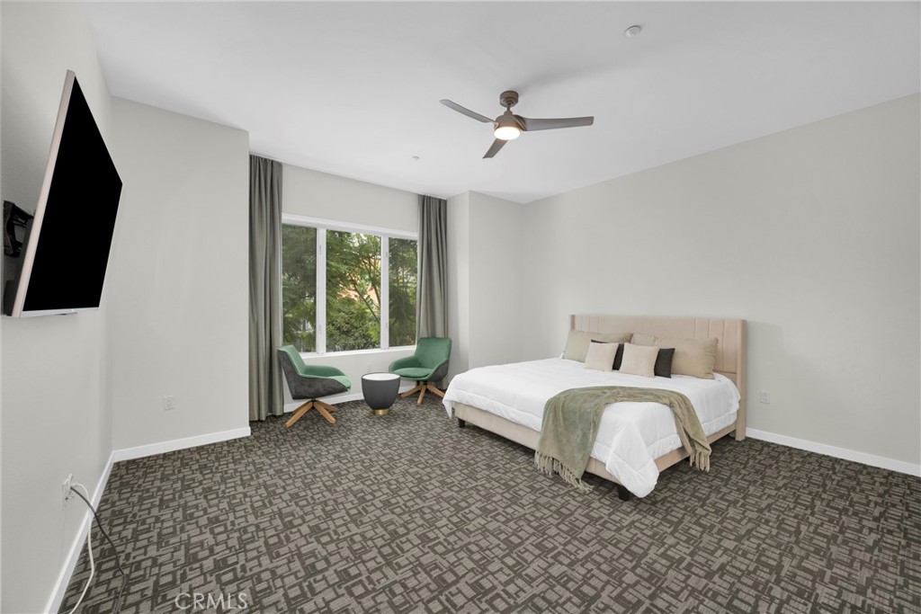 21 Gramercy, Unit 220 Irvine, CA 92612 - Photo 12 of 36 a spacious bedroom with a bed and a flat tv screen on dresser