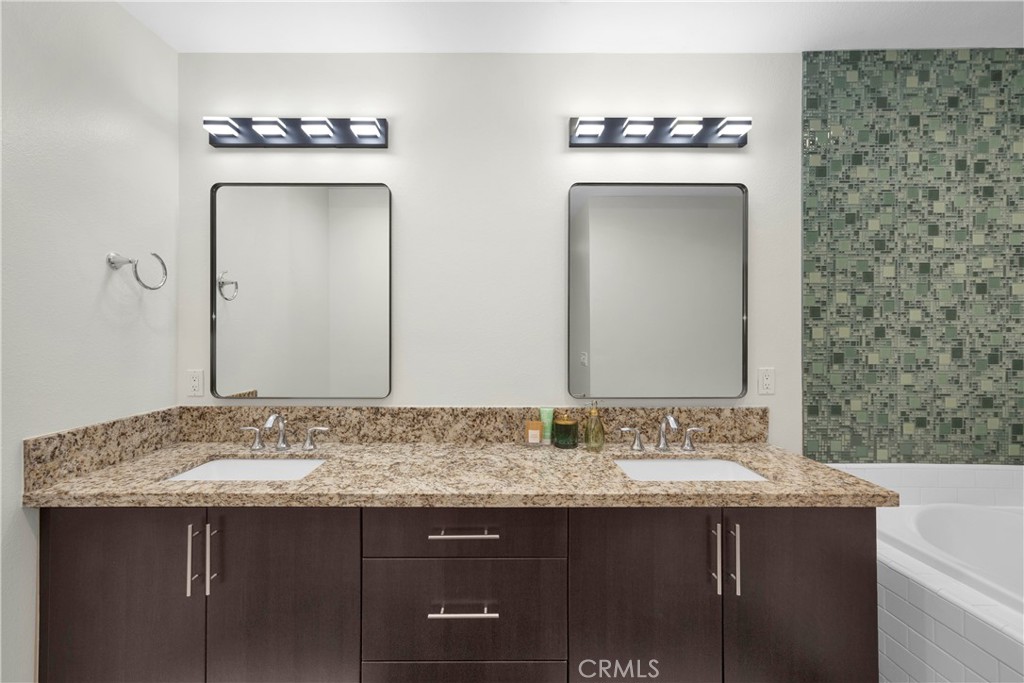 21 Gramercy, Unit 220 Irvine, CA 92612 - Photo 14 of 36 a bathroom with a sink and a mirror