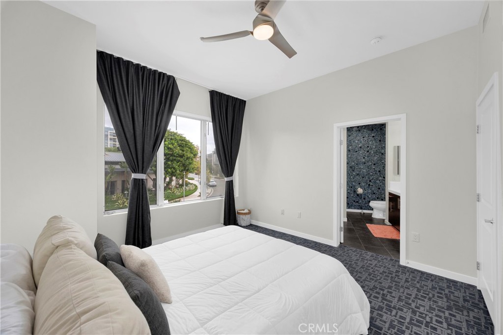 21 Gramercy, Unit 220 Irvine, CA 92612 - Photo 18 of 36 a bedroom with a bed and a large window
