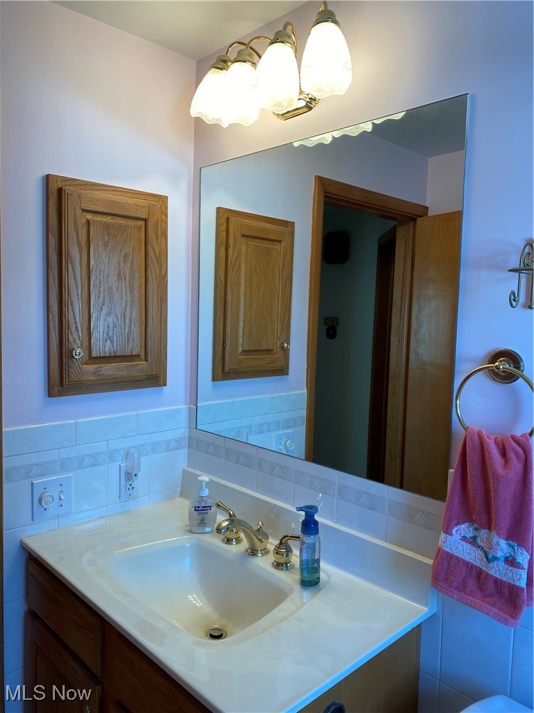 421 Omar Street Struthers, OH 44471 - Photo 14 of 31 Bathroom with vanity and tile walls