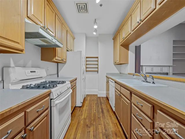a kitchen with stainless steel appliances granite countertop a stove and a sink
