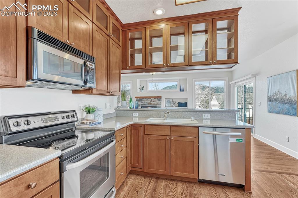 16946 Buffalo Valley Path Monument, CO 80132 - Photo 13 of 41 a kitchen with stainless steel appliances granite countertop a stove and a microwave