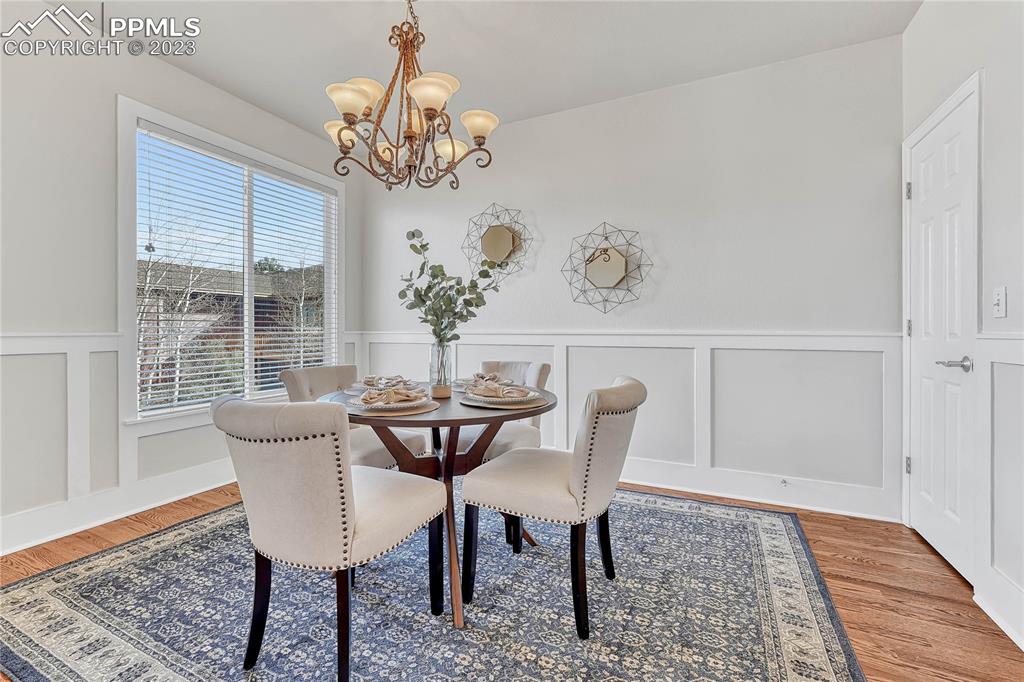 16946 Buffalo Valley Path Monument, CO 80132 - Photo 15 of 41 a dining room with furniture a rug and a chandelier