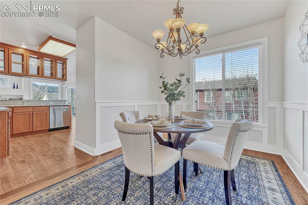 16946 Buffalo Valley Path Monument, CO 80132 - Photo 16 of 41 a view of a dining room with furniture a chandelier and wooden floor