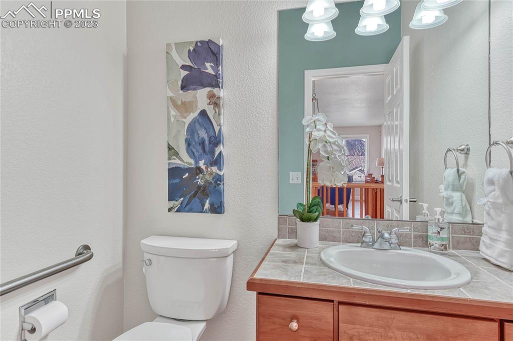 16946 Buffalo Valley Path Monument, CO 80132 - Photo 23 of 41 a bathroom with a granite countertop sink mirror vanity and toilet