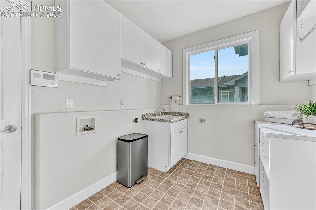 16946 Buffalo Valley Path Monument, CO 80132 - Photo 24 of 41 a kitchen with stainless steel appliances granite countertop a sink and a refrigerator