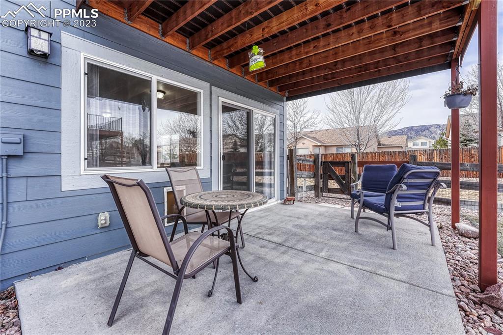 16946 Buffalo Valley Path Monument, CO 80132 - Photo 27 of 41 a patio with table and chairs and potted plants