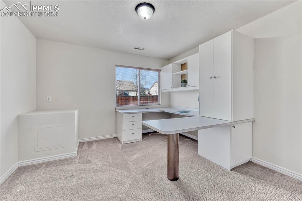 16946 Buffalo Valley Path Monument, CO 80132 - Photo 35 of 41 a kitchen with stainless steel appliances a sink cabinets and wooden floor