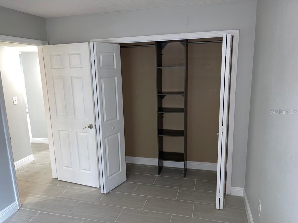 5325 Curry Ford Road, Unit B101 Orlando, FL 32812 - Photo 16 of 22 a view of closet area with empty racks