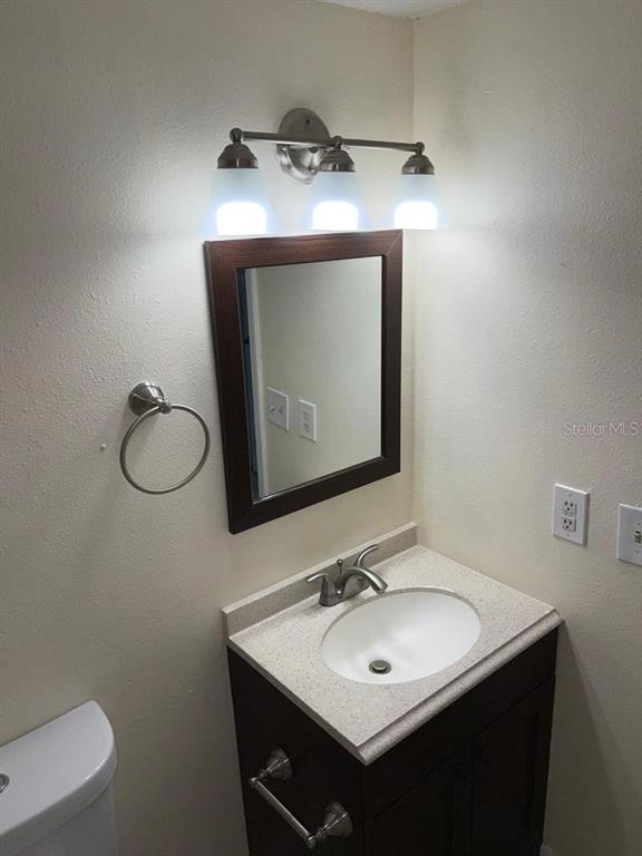 5325 Curry Ford Road, Unit B101 Orlando, FL 32812 - Photo 18 of 22 a bathroom with a toilet sink and mirror