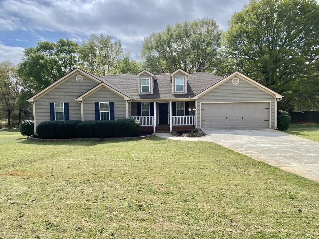 277 Harper Lane Royston, GA 30662 - Photo 1 of 42 a front view of a house with a garden and yard