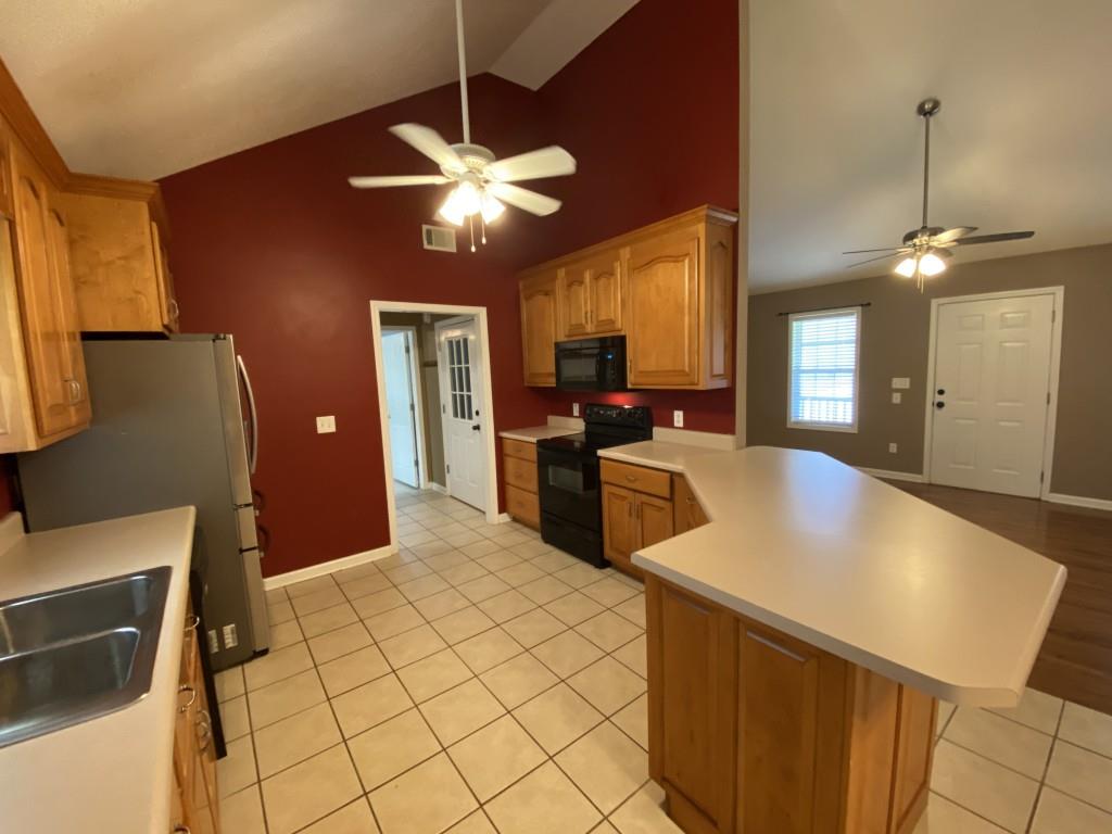 277 Harper Lane Royston, GA 30662 - Photo 14 of 42 a large kitchen with stainless steel appliances a stove refrigerator and chandelier