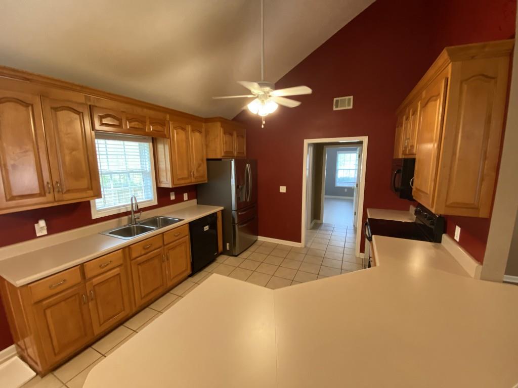 277 Harper Lane Royston, GA 30662 - Photo 15 of 42 a large kitchen with stainless steel appliances granite countertop a sink a stove and a refrigerator