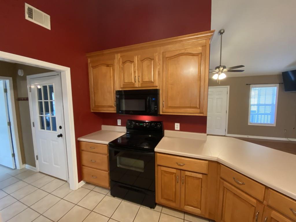 277 Harper Lane Royston, GA 30662 - Photo 16 of 42 a kitchen with stainless steel appliances granite countertop a sink and a microwave
