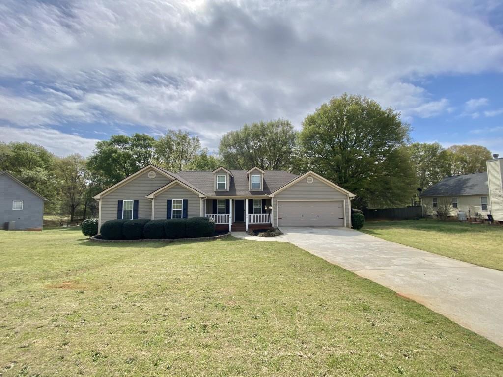 277 Harper Lane Royston, GA 30662 - Photo 2 of 42 a front view of a house with a yard and garage