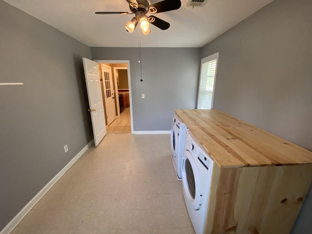 277 Harper Lane Royston, GA 30662 - Photo 22 of 42 a utility room with a sink a washer and dryer