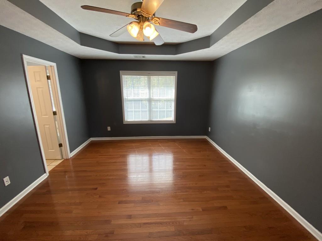 277 Harper Lane Royston, GA 30662 - Photo 29 of 42 an empty room with wooden floor and windows