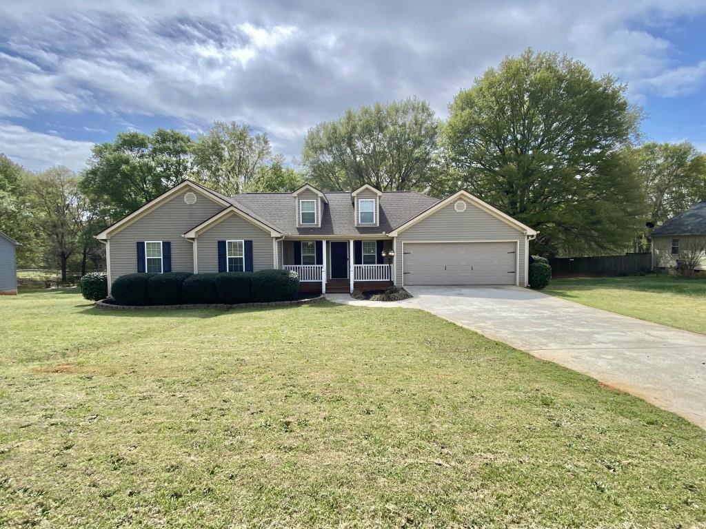 277 Harper Lane Royston, GA 30662 - Photo 3 of 42 a front view of a house with a garden and tree