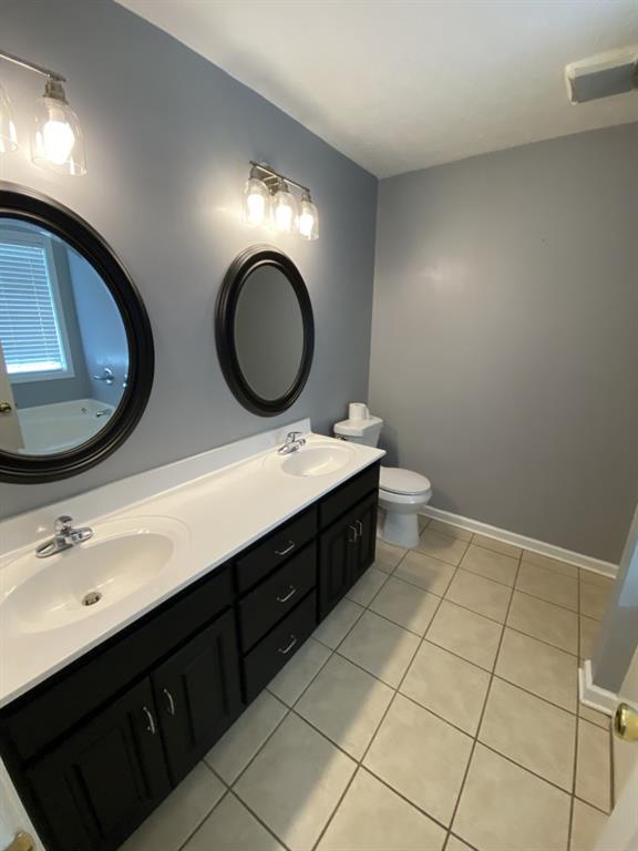 277 Harper Lane Royston, GA 30662 - Photo 31 of 42 a bathroom with a double vanity sink and a mirror