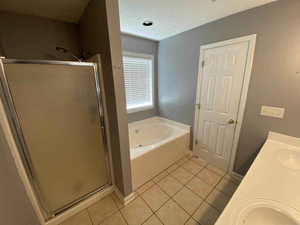 277 Harper Lane Royston, GA 30662 - Photo 32 of 42 a bathroom with a tub shower and a sink