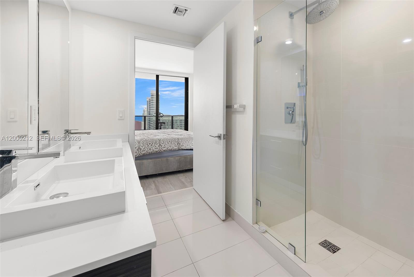 45 Southwest 9th Street, Unit 4006 Miami, FL 33130 - Photo 11 of 62 a en suite bathroom with a sink and a large mirror