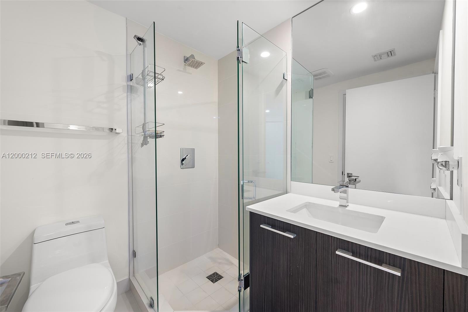 45 Southwest 9th Street, Unit 4006 Miami, FL 33130 - Photo 15 of 62 a bathroom with a sink a toilet and shower