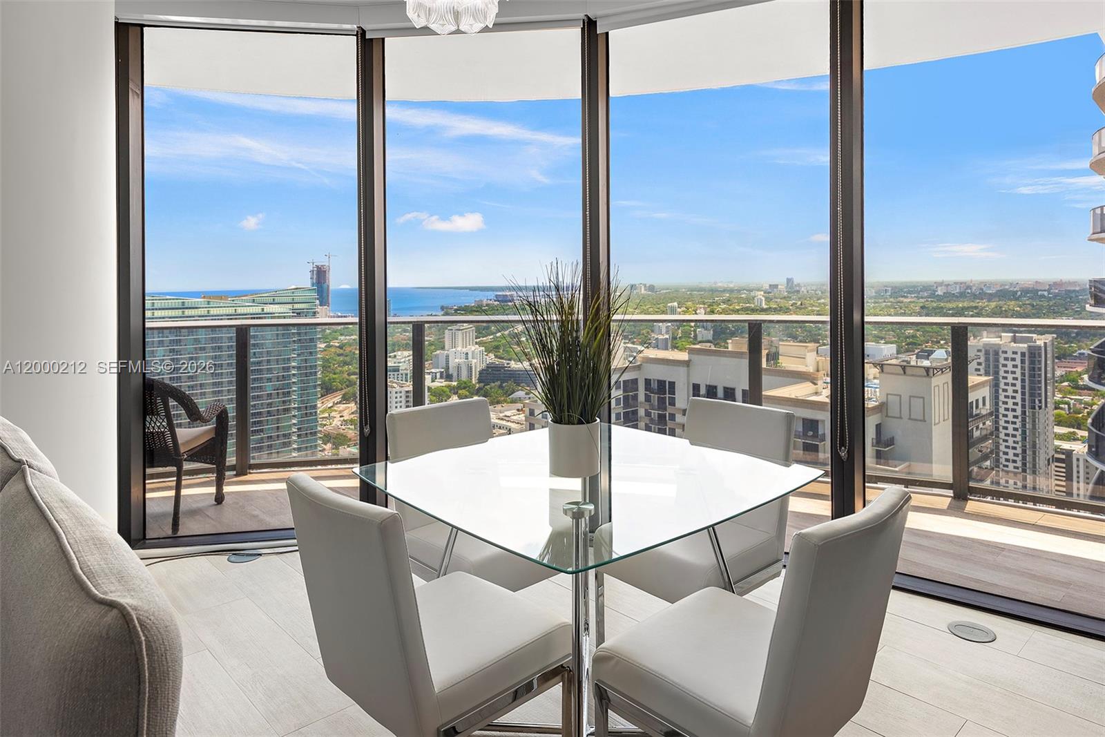 45 Southwest 9th Street, Unit 4006 Miami, FL 33130 - Photo 2 of 62 a dining room with furniture large windows and view of balcony