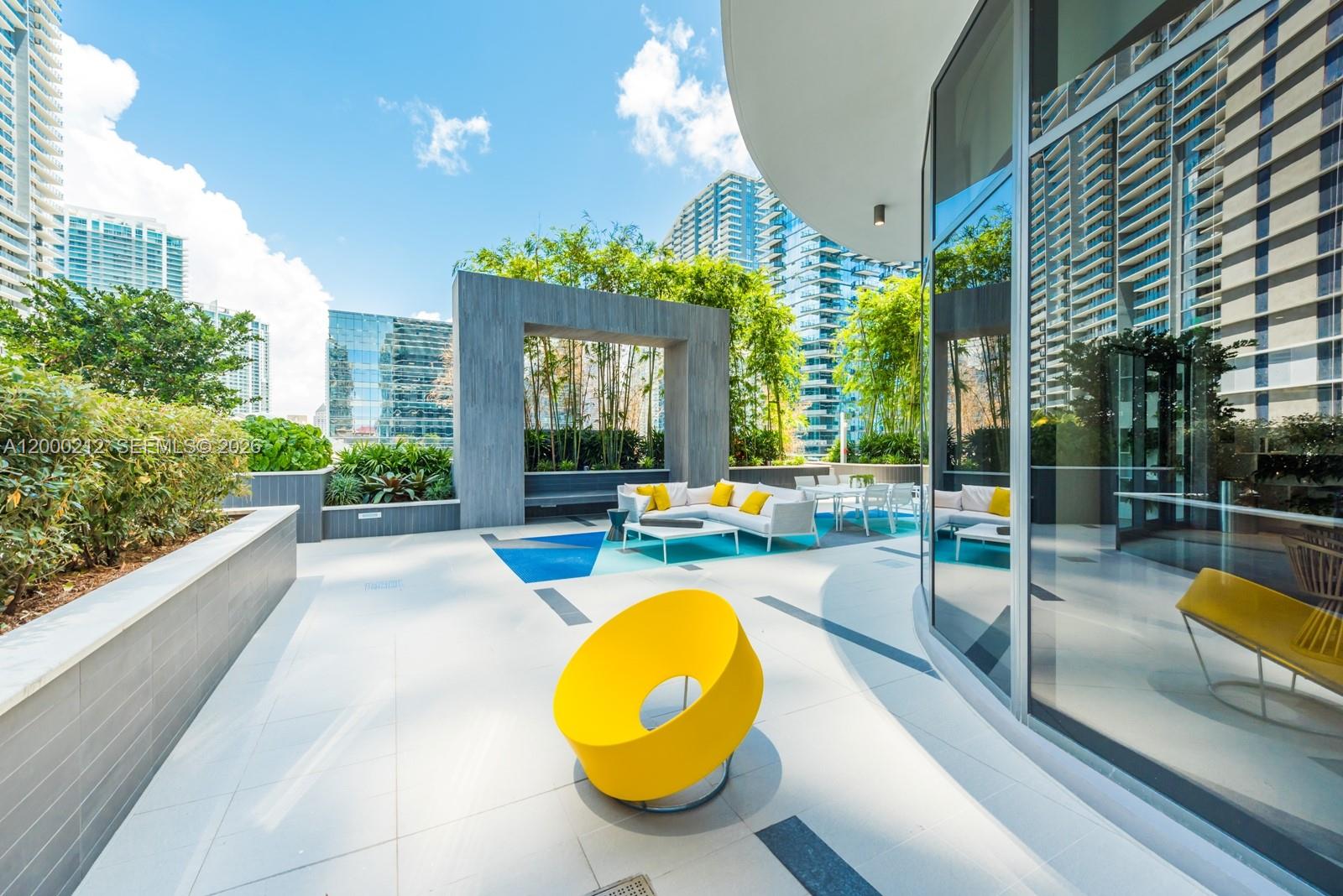 45 Southwest 9th Street, Unit 4006 Miami, FL 33130 - Photo 50 of 62 a view of a swimming pool with a patio and dining space
