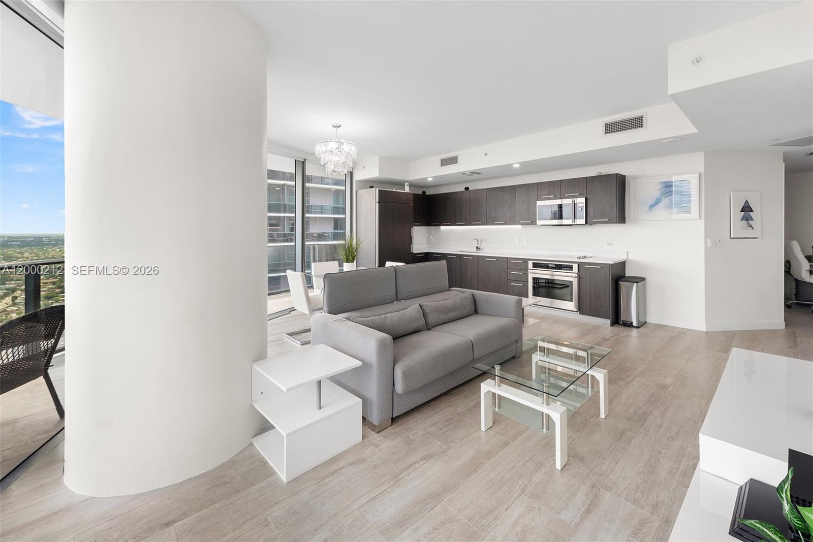 45 Southwest 9th Street, Unit 4006 Miami, FL 33130 - Photo 6 of 62 a living room with furniture and a flat screen tv