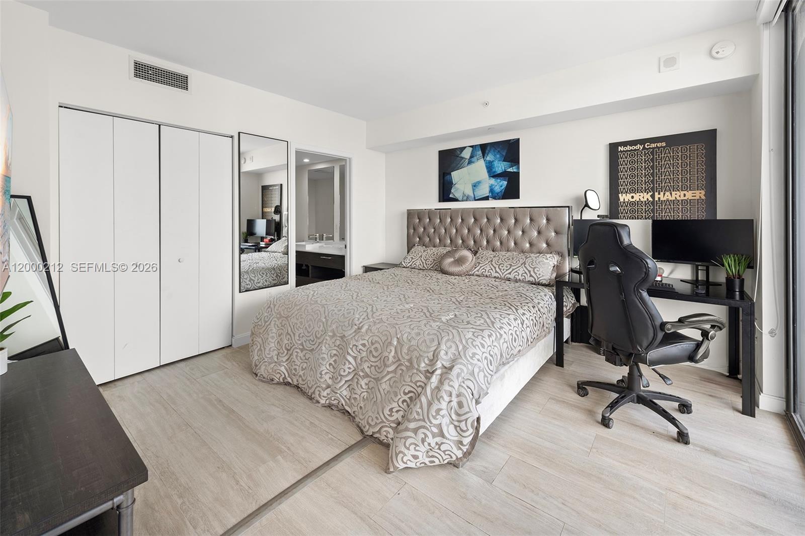 45 Southwest 9th Street, Unit 4006 Miami, FL 33130 - Photo 7 of 62 a large bedroom with a bed and wooden floor