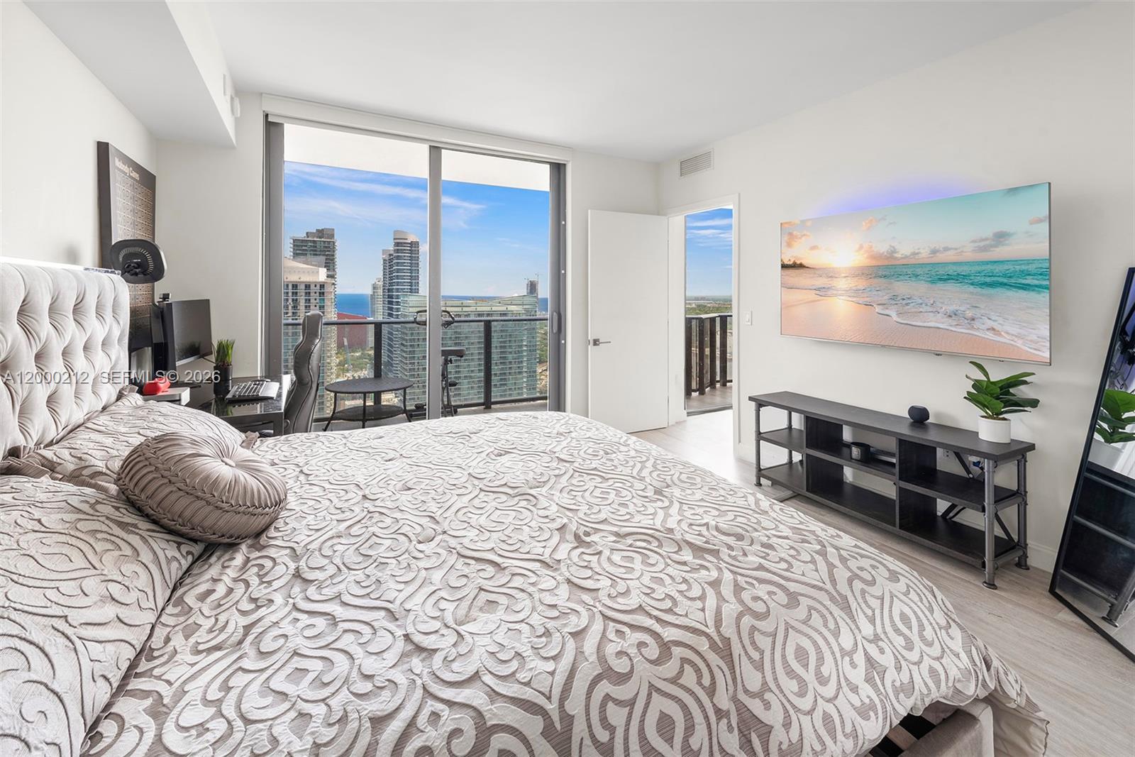 45 Southwest 9th Street, Unit 4006 Miami, FL 33130 - Photo 8 of 62 a bed room with a bed and a chair