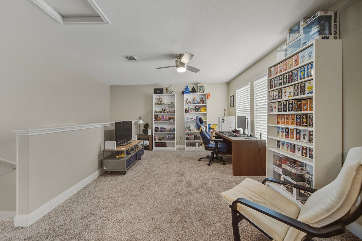 2207 Lauren Loop Leander, TX 78641 - Photo 12 of 26 a livingroom with workspace and a window