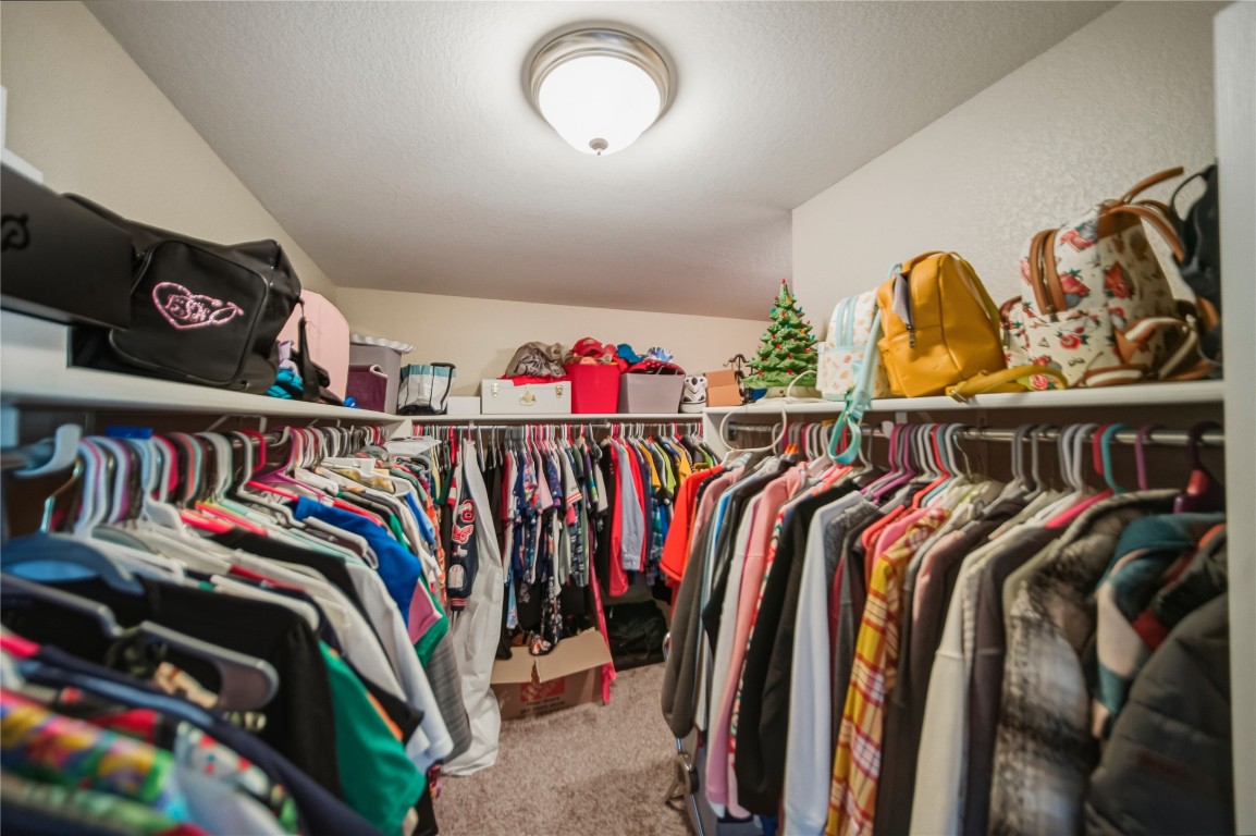 2207 Lauren Loop Leander, TX 78641 - Photo 16 of 26 a view of walk in closet with clothes and shoes