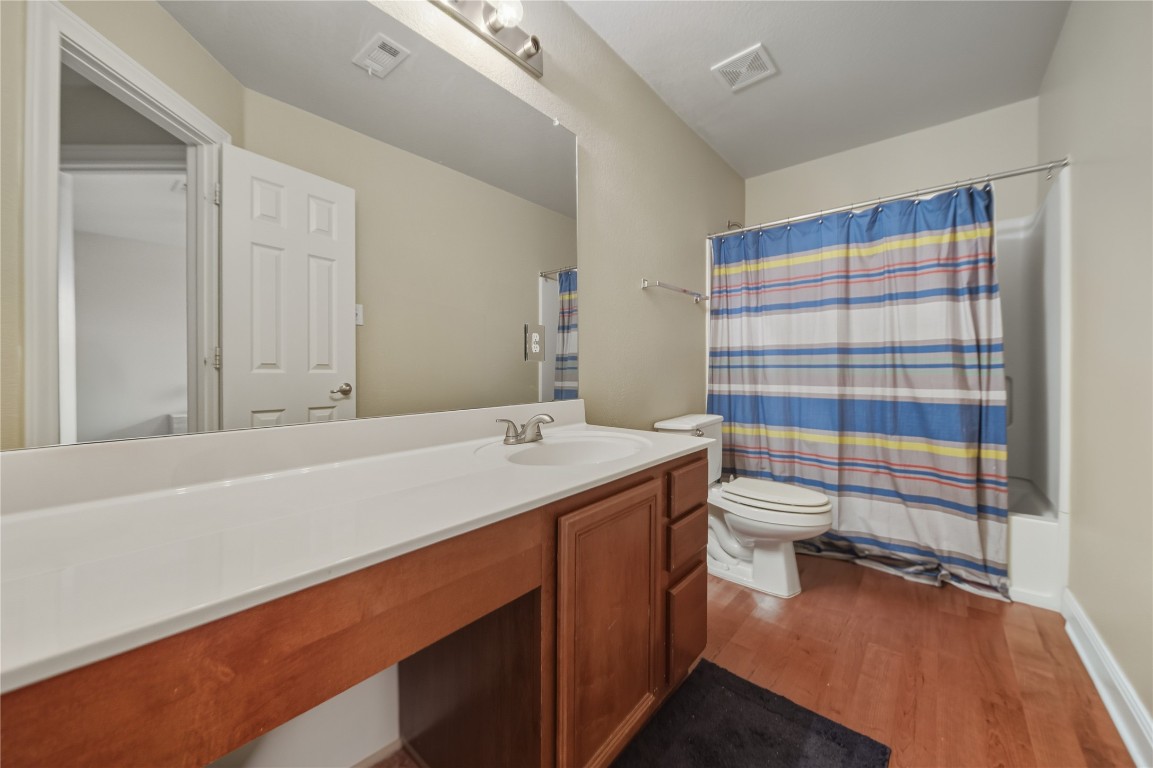 2207 Lauren Loop Leander, TX 78641 - Photo 19 of 26 a bathroom with a sink toilet and shower