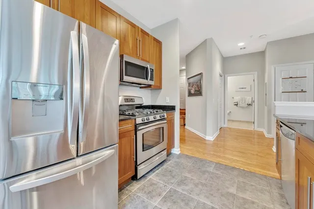 a kitchen with stainless steel appliances a refrigerator stove and microwave
