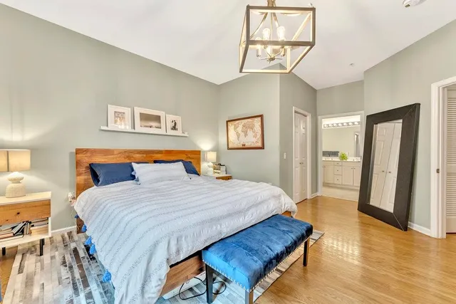 a bedroom with a bed and a chandelier