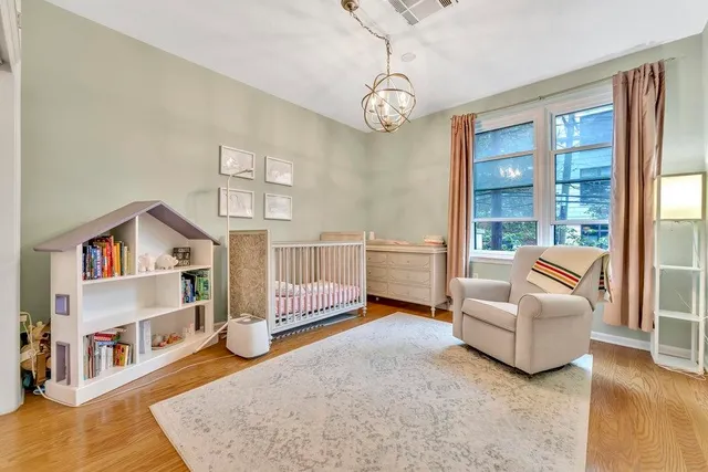 a living room with furniture and a book shelf