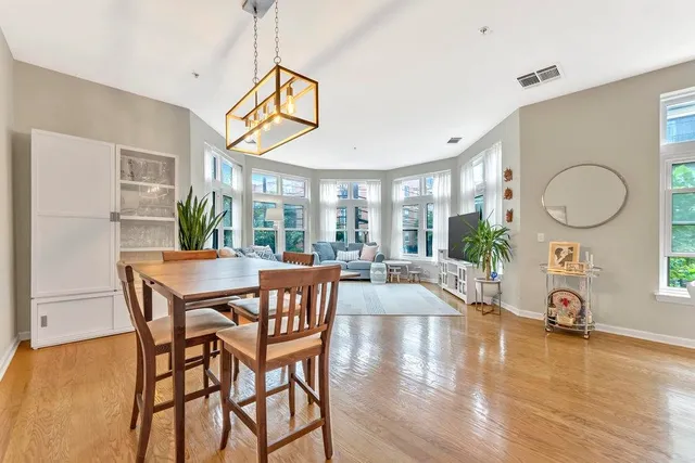 a view of a dining room with furniture window and wooden floor