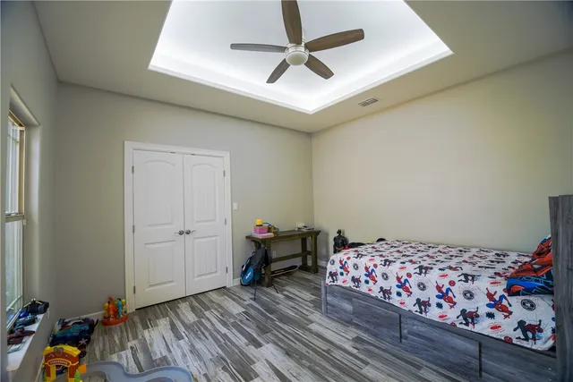 a bedroom with bed and a chandelier