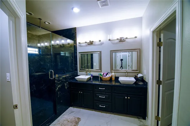 a bathroom with a double vanity sink and mirror