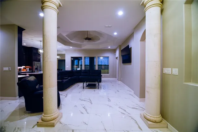 a living room with furniture and a wooden floor