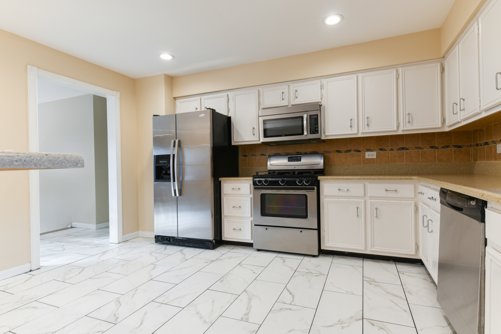 310 Dancing Water Court Carol Stream, IL 60188 - Photo 7 of 26 a kitchen with stainless steel appliances granite countertop a refrigerator and a stove top oven